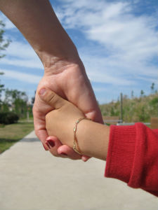 Adoption helps build beautiful families. adopted child holding parent's hand