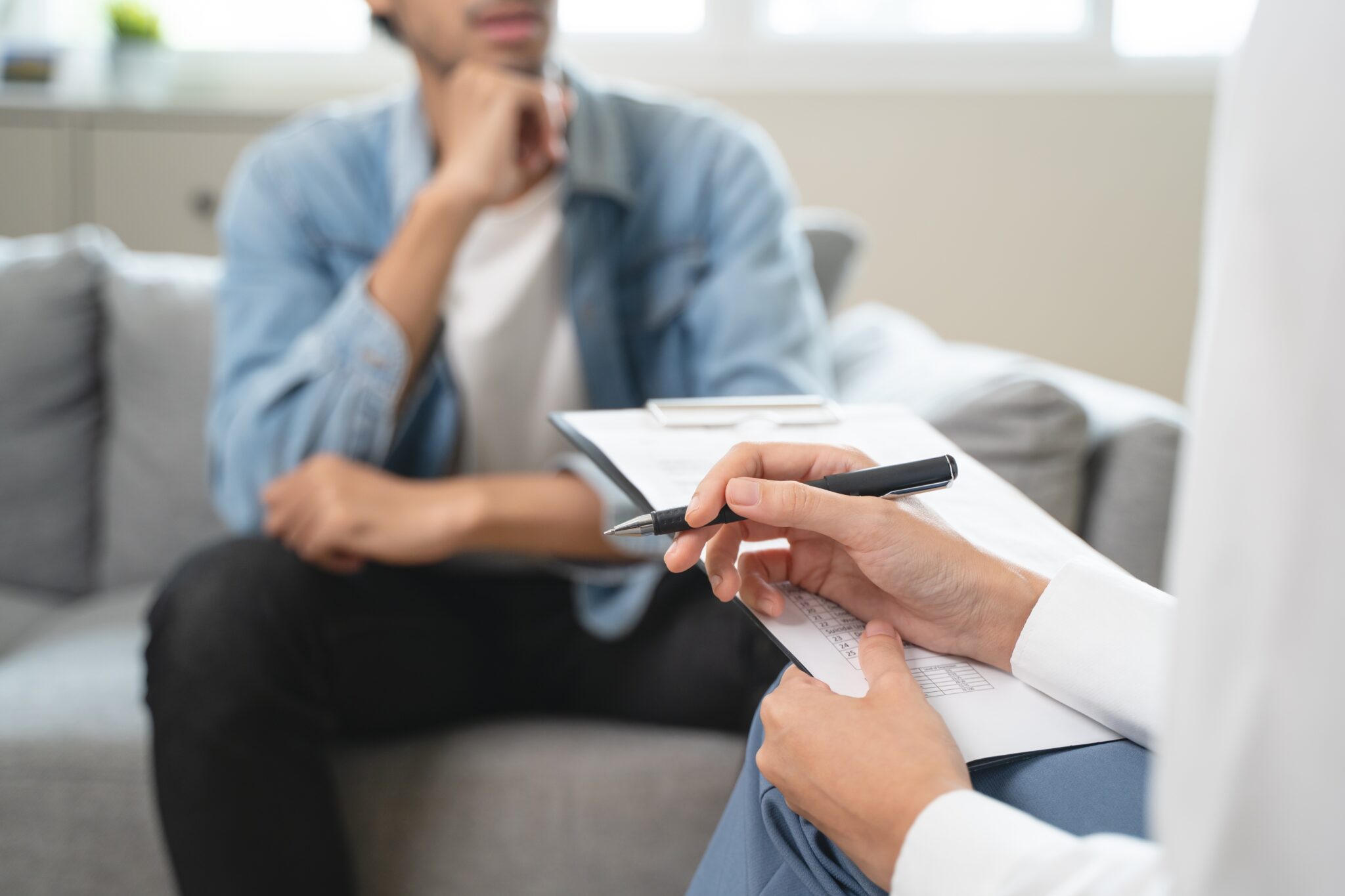 Man sitting in chair while provider takes notes